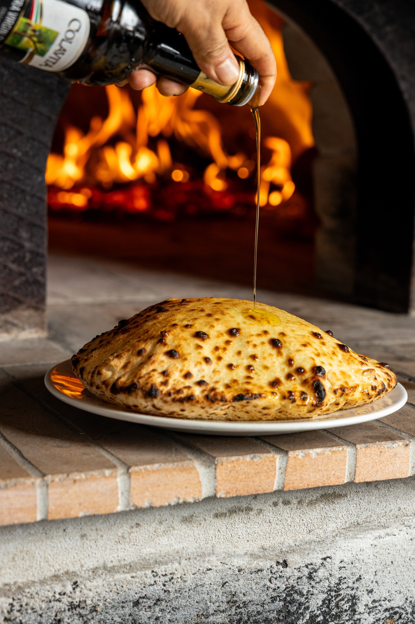 Wood-fired calzone with olive oil at Casa Di Amore